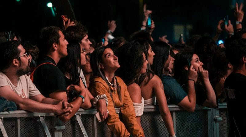 Thousands of fans holding lightsticks at a K-Pop stadium concert