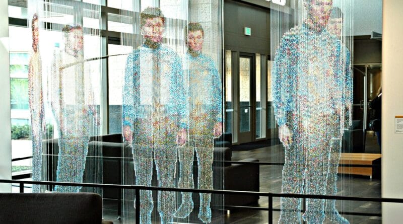 Solo entrepreneur managing an empire using AI automation tools on multiple screens.