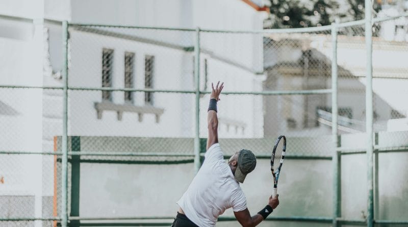 Tennis racquet and ball on a clay court symbolizing the grand slam tournaments