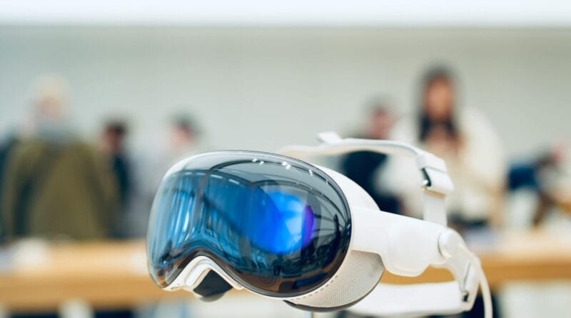 A concept render of sleek, minimalist augmented reality glasses, rumored to be Apple's new "Vision Air" device, displaying digital information over a city street view instead of a smartphone screen.